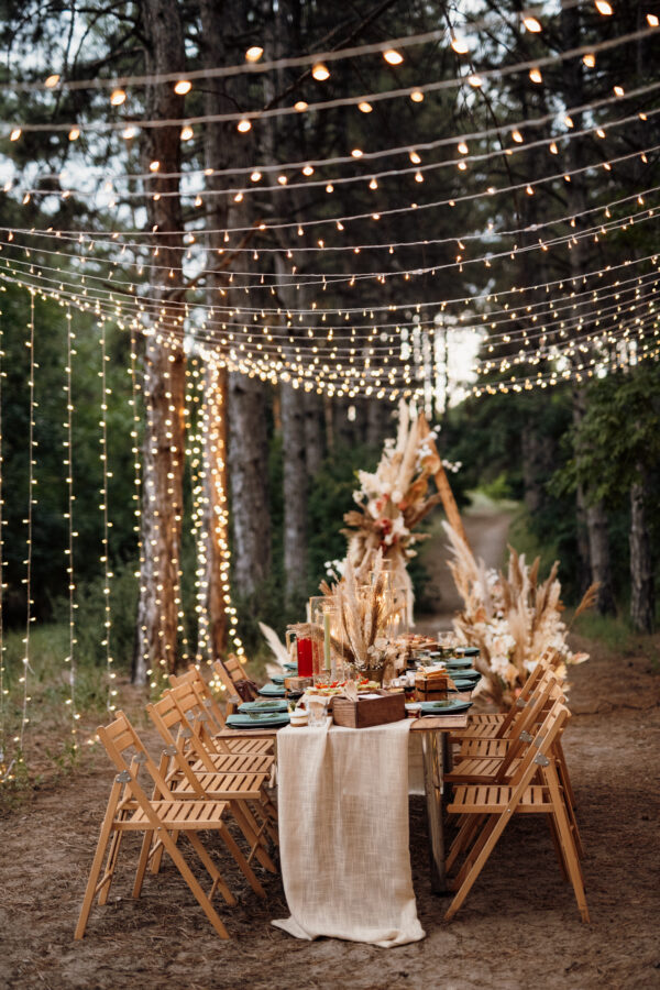 wedding banquet area in a pine forest with an arch on the backgr